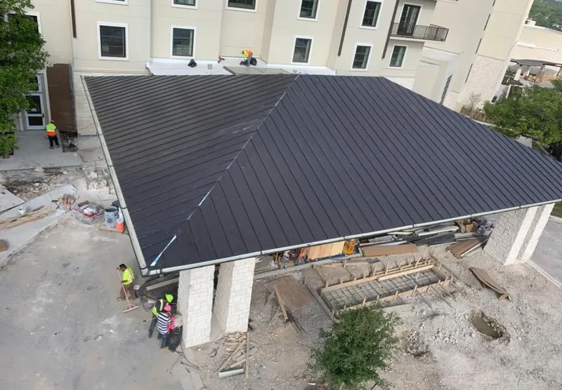 Metal roofing installation team working on a commercial building in Tullahoma